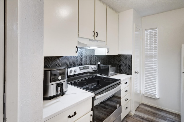 kitchen featuring white cabinetry, electric range, dark hardwood / wood-style floors, a textured ceiling, and decorative backsplash