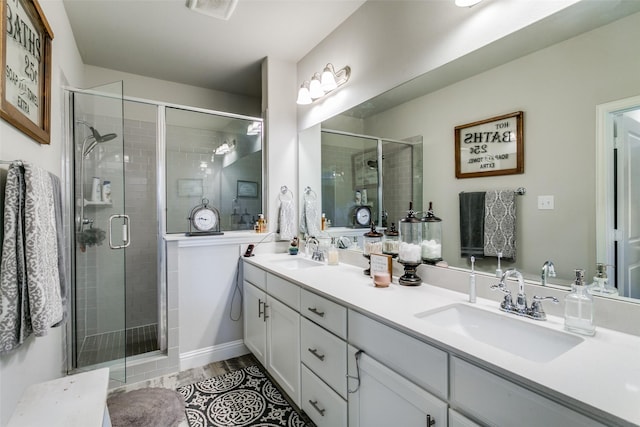 bathroom with hardwood / wood-style flooring, vanity, and a shower with shower door