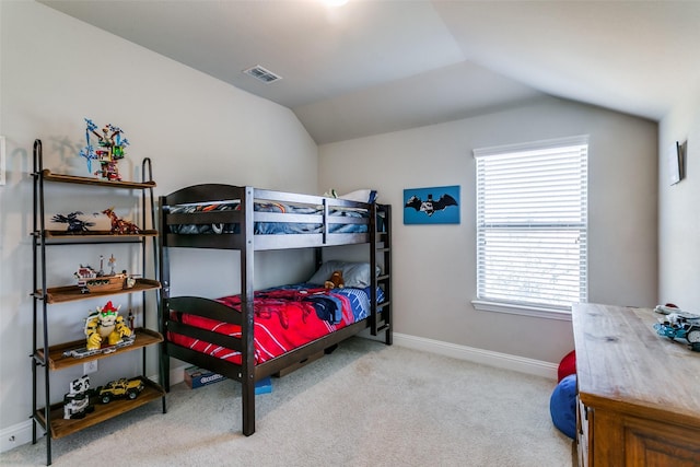 bedroom featuring vaulted ceiling and light carpet