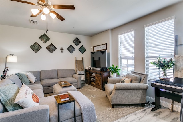 living room featuring ceiling fan and light wood-type flooring