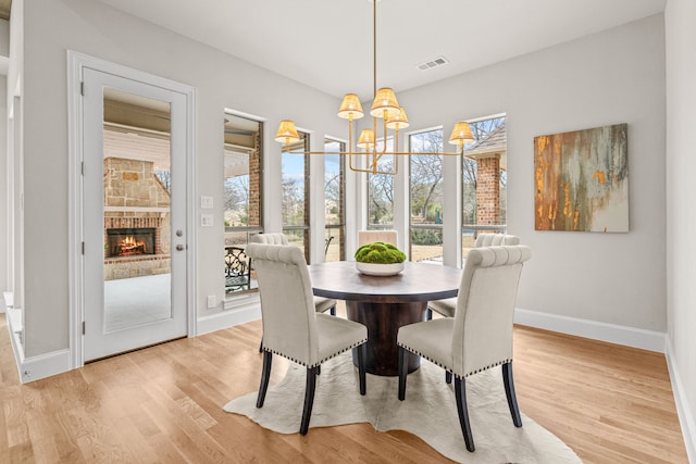 dining room featuring an inviting chandelier and light hardwood / wood-style flooring