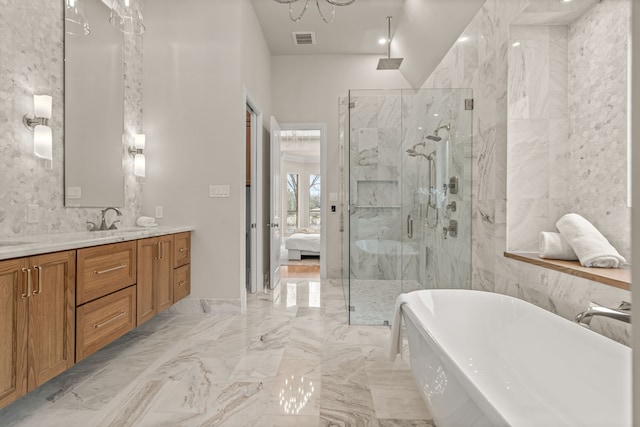 bathroom featuring vanity and shower with separate bathtub