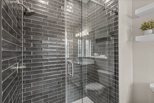 bathroom featuring a shower with shower door