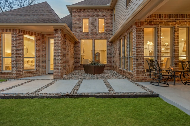 view of exterior entry featuring a patio