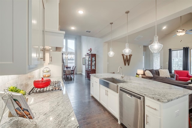 kitchen featuring sink, white cabinetry, hanging light fixtures, appliances with stainless steel finishes, and light stone countertops