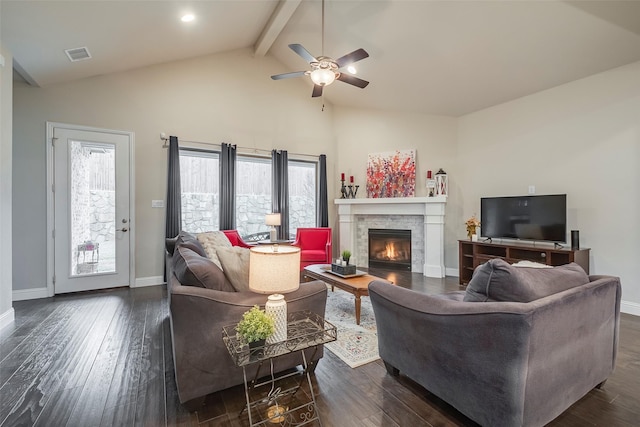 living room featuring dark wood-type flooring, a fireplace, and beamed ceiling