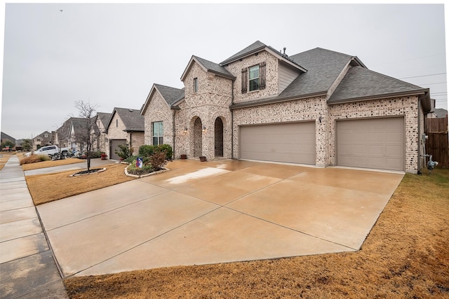 french country style house featuring a garage