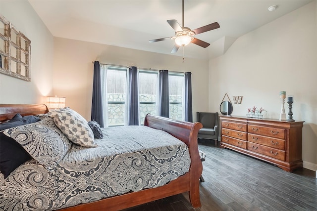 bedroom with dark hardwood / wood-style flooring and ceiling fan