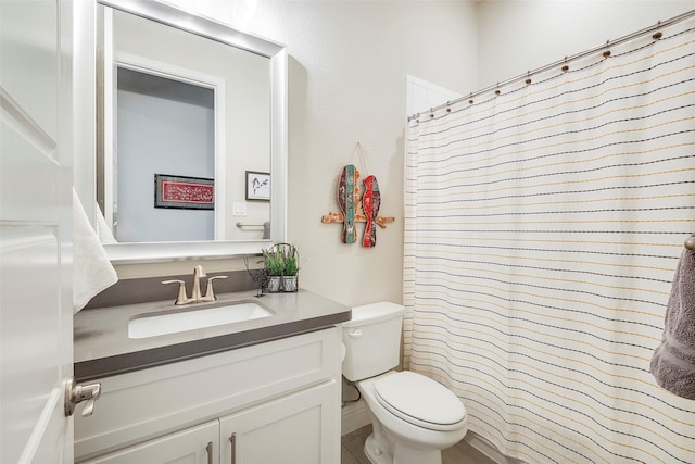 bathroom with vanity, a shower with shower curtain, and toilet