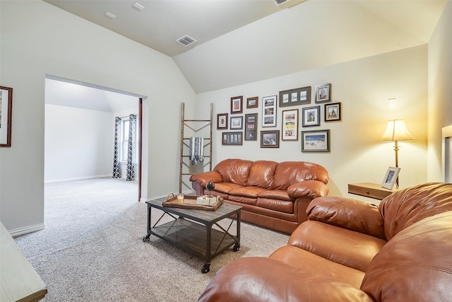 carpeted living room with vaulted ceiling