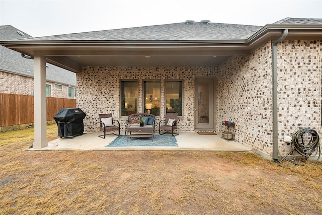 rear view of house with outdoor lounge area and a patio