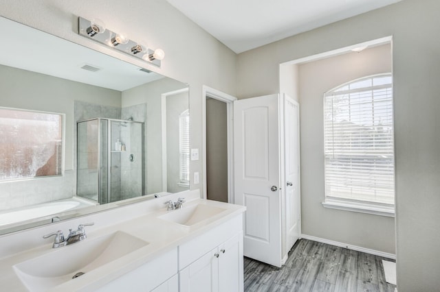 bathroom with vanity, plus walk in shower, and hardwood / wood-style floors