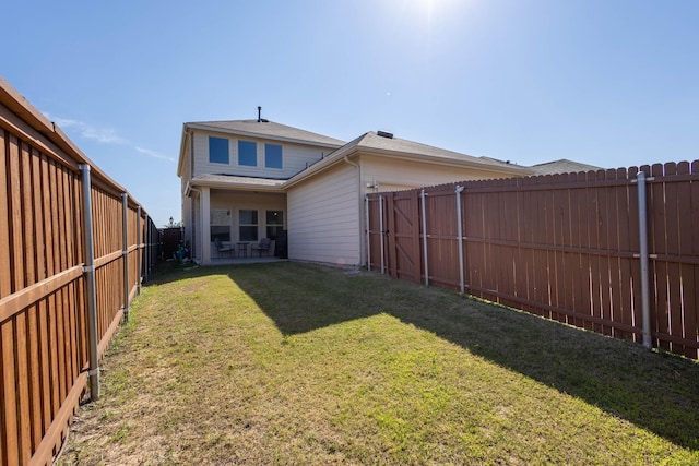 back of house featuring a yard