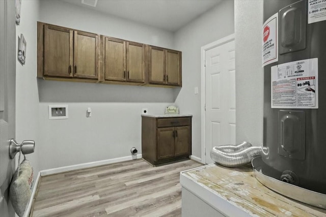 clothes washing area featuring cabinets, hookup for a washing machine, electric water heater, electric dryer hookup, and light hardwood / wood-style floors