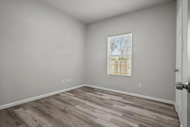 spare room with hardwood / wood-style flooring