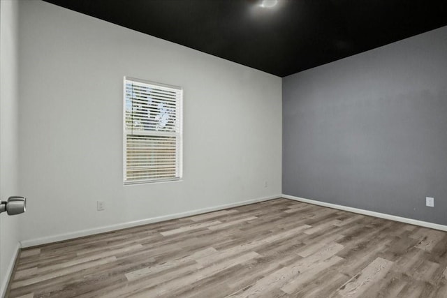 unfurnished room with light hardwood / wood-style flooring