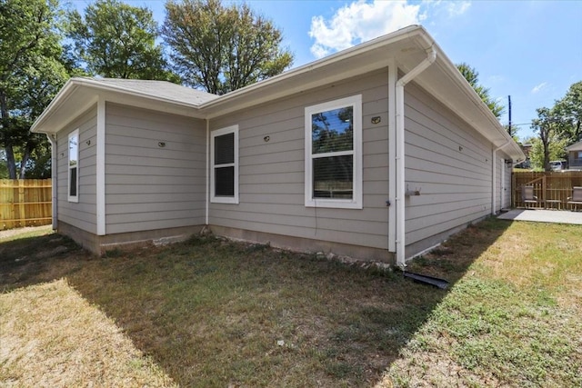 view of side of property with a yard