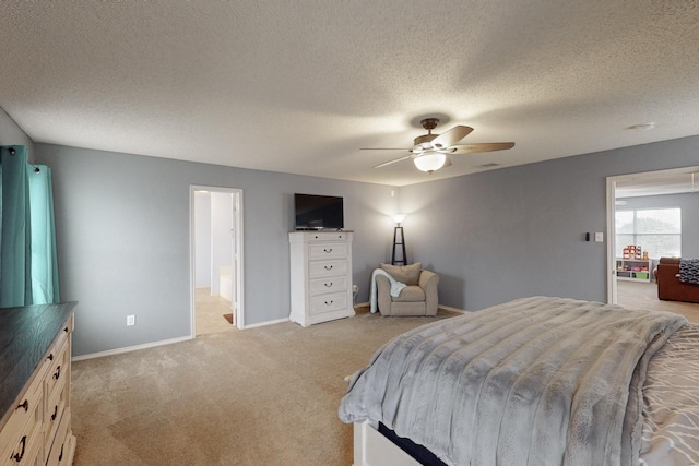 carpeted bedroom featuring ceiling fan and a textured ceiling