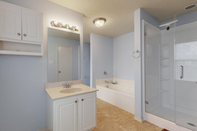 bathroom with independent shower and bath, vanity, and a textured ceiling