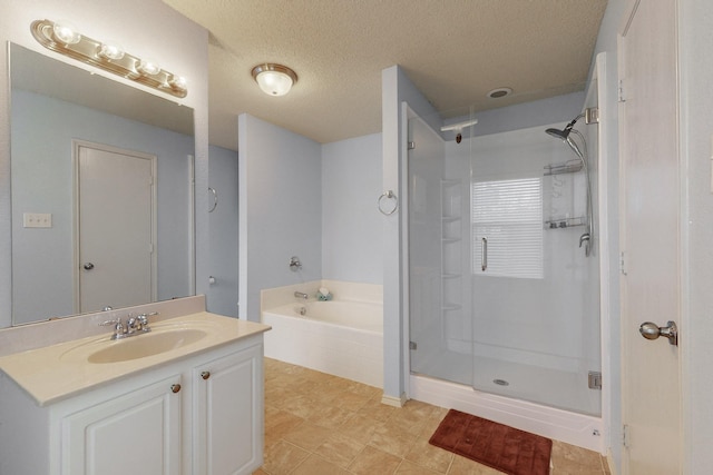 bathroom featuring shower with separate bathtub, vanity, and a textured ceiling