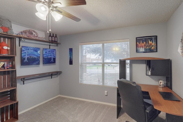 home office with ceiling fan, light carpet, and a textured ceiling