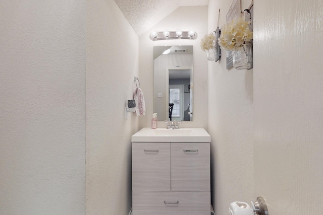 bathroom with vanity and vaulted ceiling