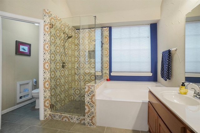 full bathroom featuring vanity, tile patterned floors, shower with separate bathtub, and toilet