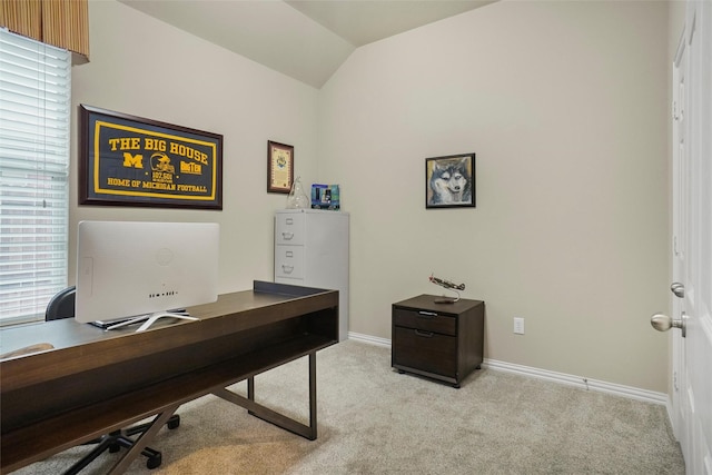 carpeted home office featuring lofted ceiling