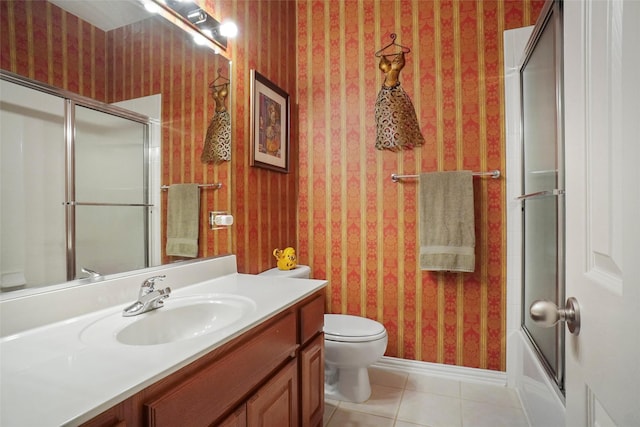 full bathroom with toilet, tile patterned floors, bath / shower combo with glass door, and vanity