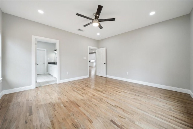 unfurnished bedroom with ensuite bathroom, ceiling fan, and light hardwood / wood-style floors