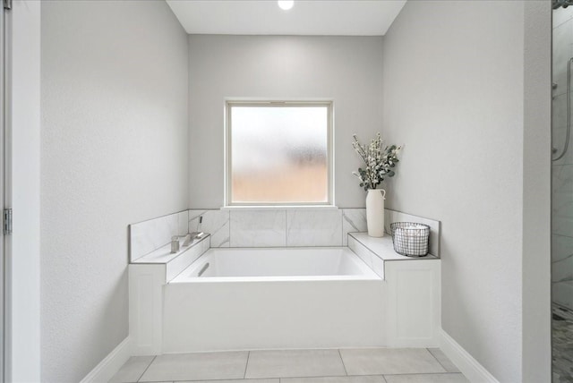 bathroom with tile patterned flooring and a bathing tub