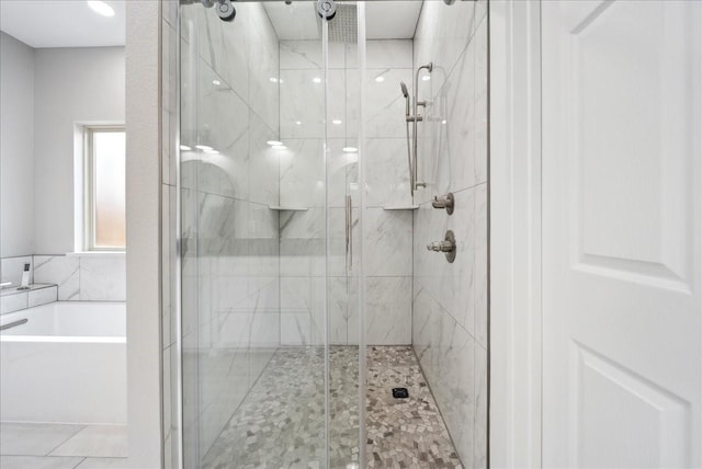 bathroom with separate shower and tub