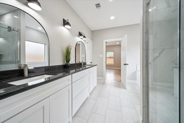 bathroom with vanity, a shower with shower door, and tile patterned flooring