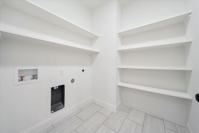 clothes washing area with washer hookup and hookup for an electric dryer