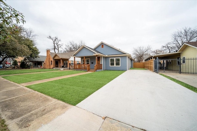 view of front facade with a front lawn, a carport, and a porch