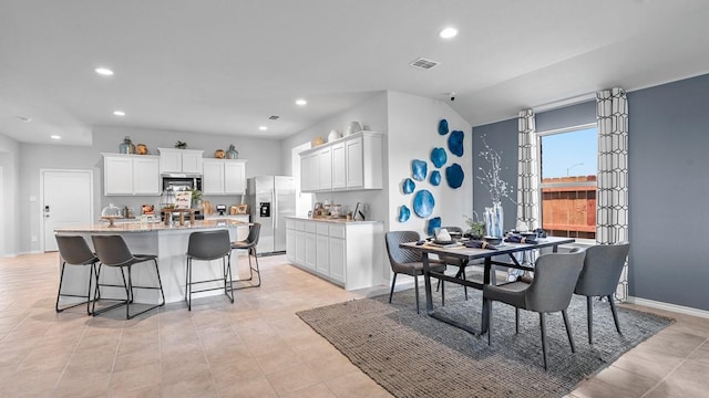 dining space featuring light tile patterned floors