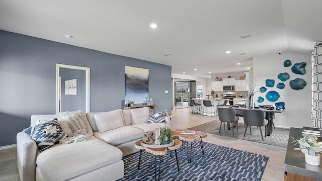 living room featuring lofted ceiling