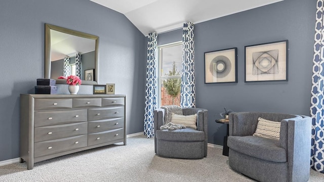 sitting room with vaulted ceiling and light colored carpet