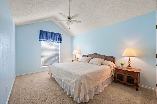 carpeted bedroom with vaulted ceiling, ceiling fan, and a textured ceiling