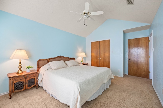 carpeted bedroom featuring ceiling fan, vaulted ceiling, and a closet