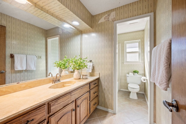 bathroom with vanity, tile patterned floors, a textured ceiling, and toilet