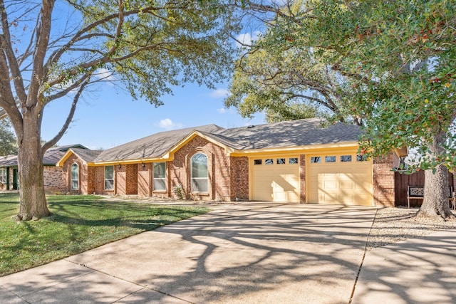 ranch-style home featuring a garage and a front yard