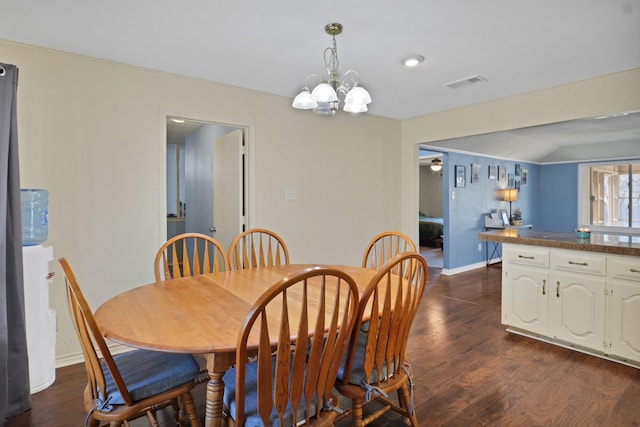 dining room with dark hardwood / wood-style floors and a chandelier