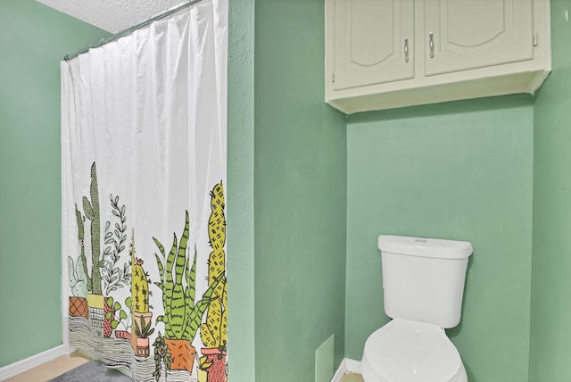 bathroom with a shower with curtain and toilet