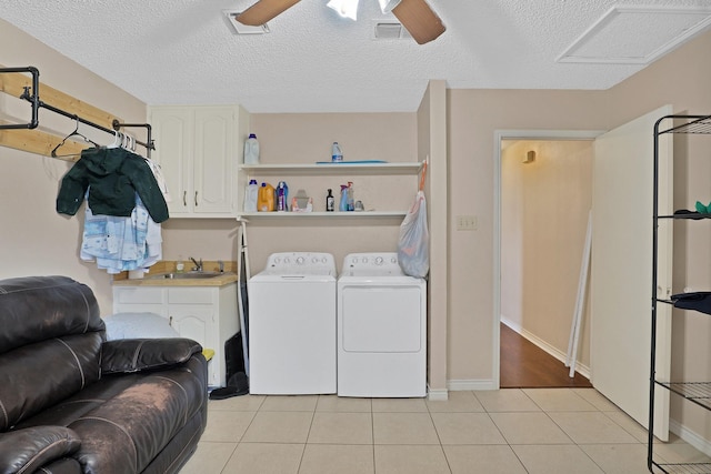 laundry room featuring sink, cabinets, light tile patterned floors, washing machine and clothes dryer, and ceiling fan