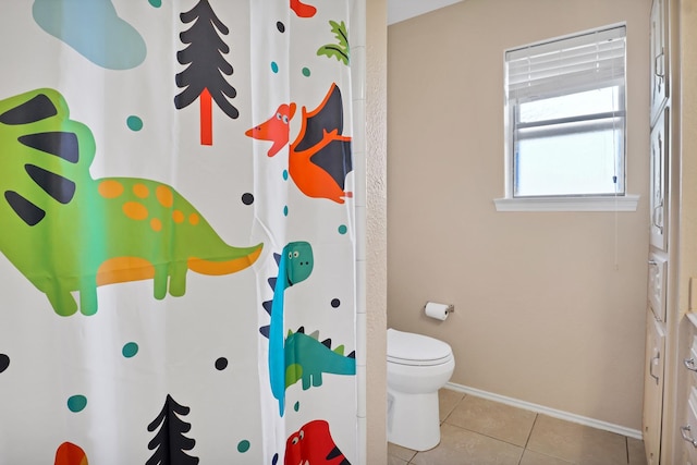 bathroom featuring toilet and tile patterned flooring