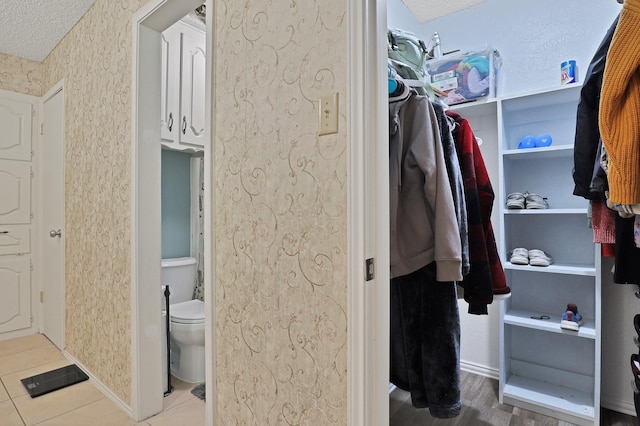 spacious closet with light tile patterned floors