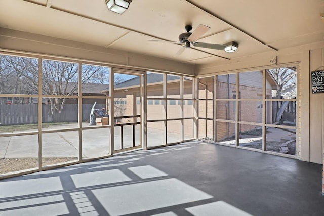 unfurnished sunroom featuring ceiling fan