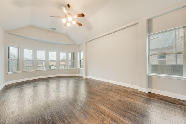 spare room with vaulted ceiling, dark wood-type flooring, and ceiling fan