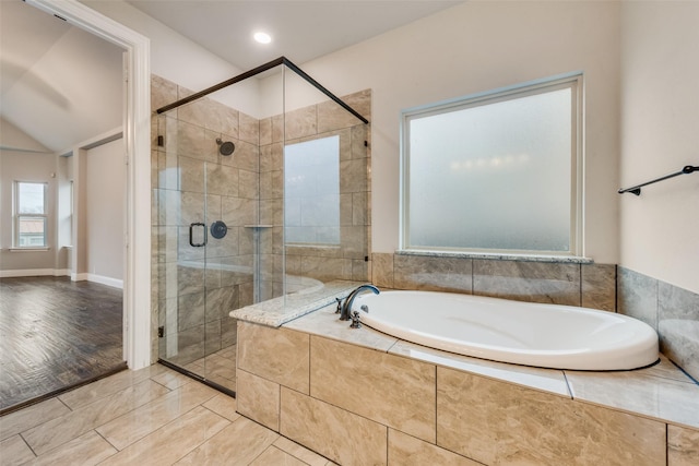 bathroom featuring lofted ceiling, hardwood / wood-style flooring, and separate shower and tub